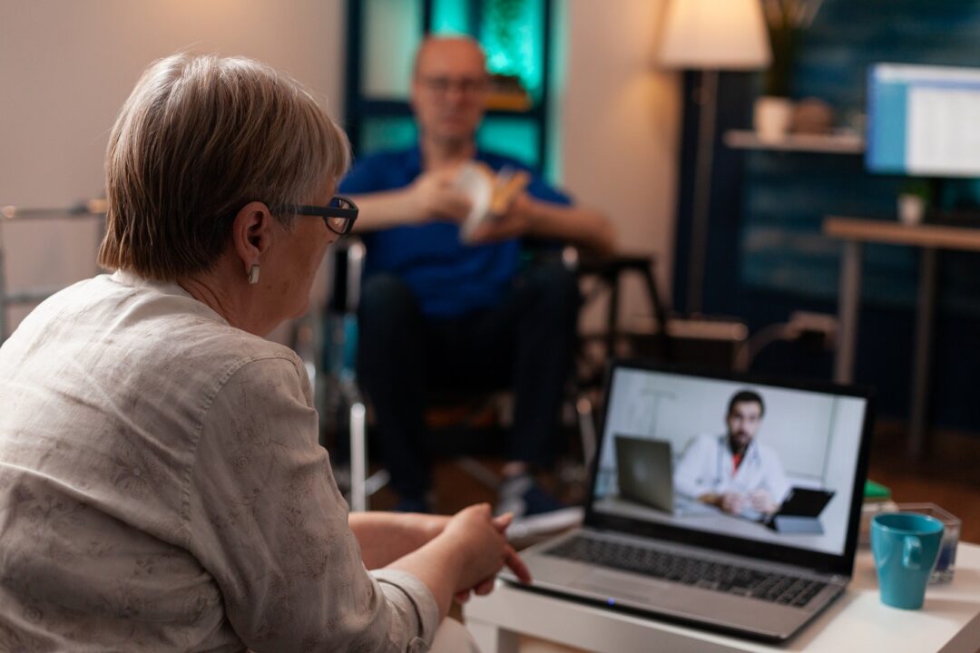 Elder Unwell Woman Calling Doctor At Clinic Using Video Call