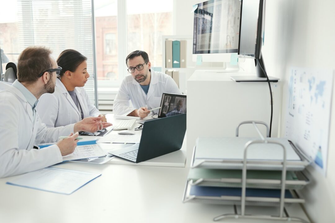 Doctors Discussing Disease At Meeting