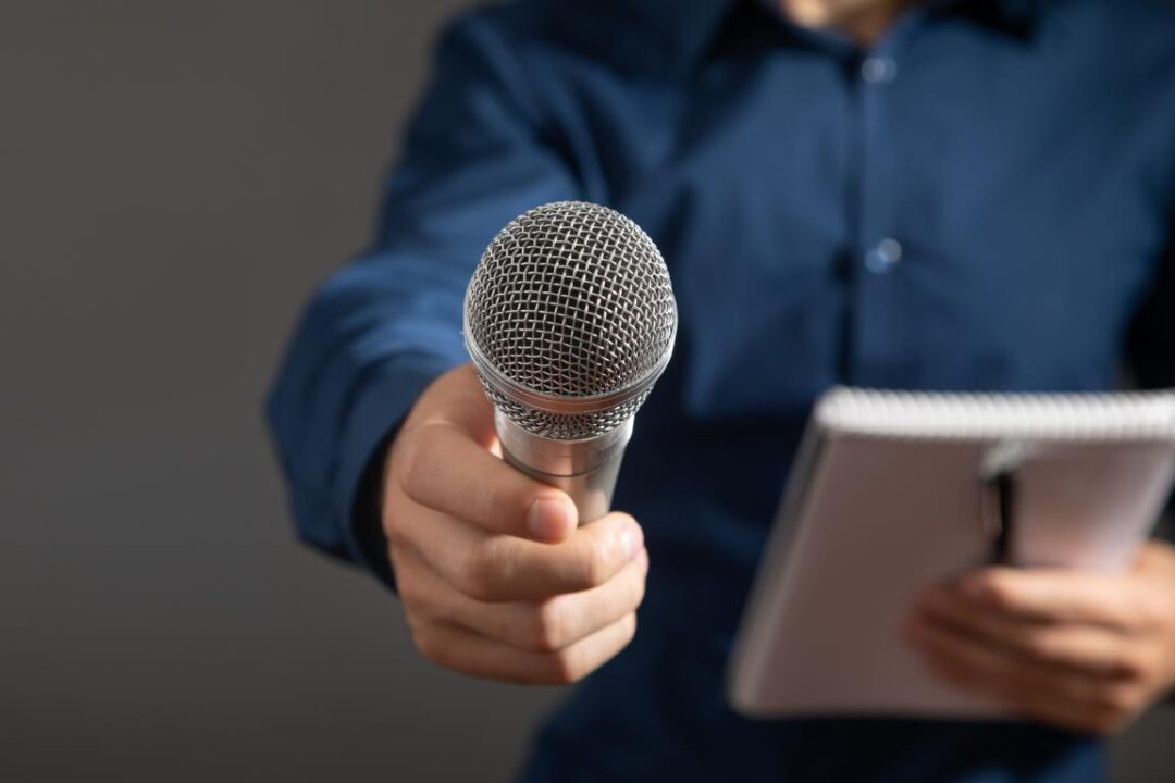 Caucasian Journalist Holding Microphone Notepad Pen 1