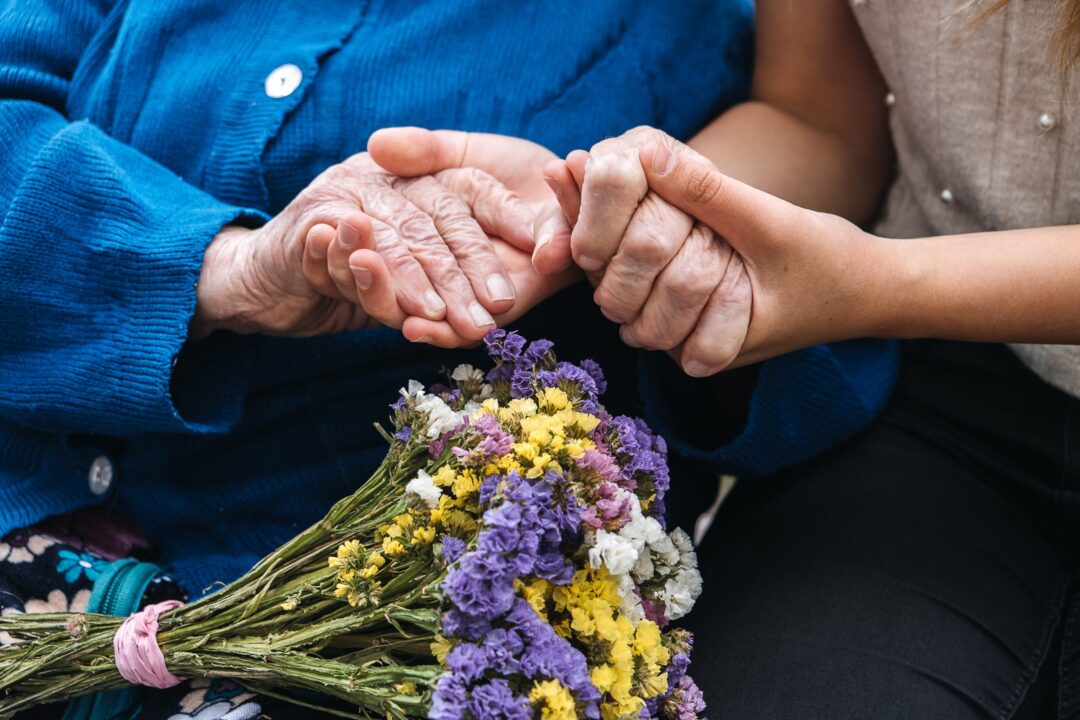 charities-for-elderly-people-young-hands-holding-old-elderly-senior-hands-support-for-the-seniors-concept-scaled