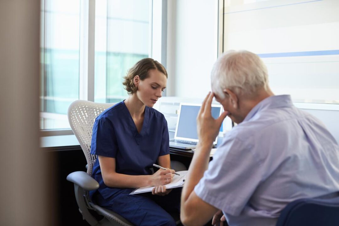 Doctor In Consultation With Depressed Male Patient