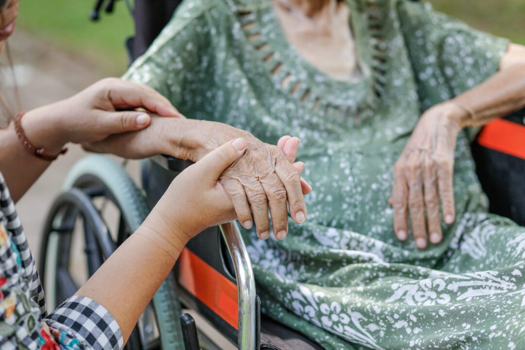 elderly-asian-woman-on-wheelchair-at-home-with-daughter-take-care-scaled