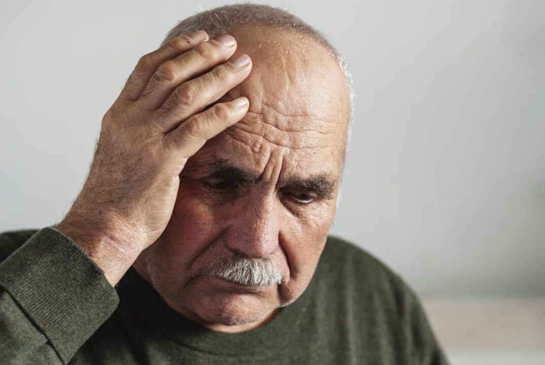 Forgetful Senior Man Holding A Hand To His Head 1