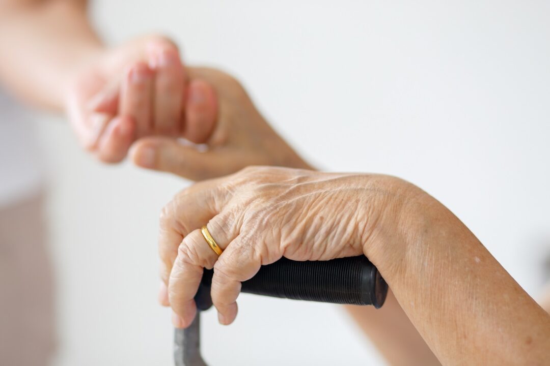Elderly Asian Woman Using A Cane At Home With Caregiver Take Car