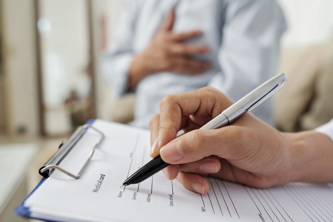Doctor Filling The Medical Card