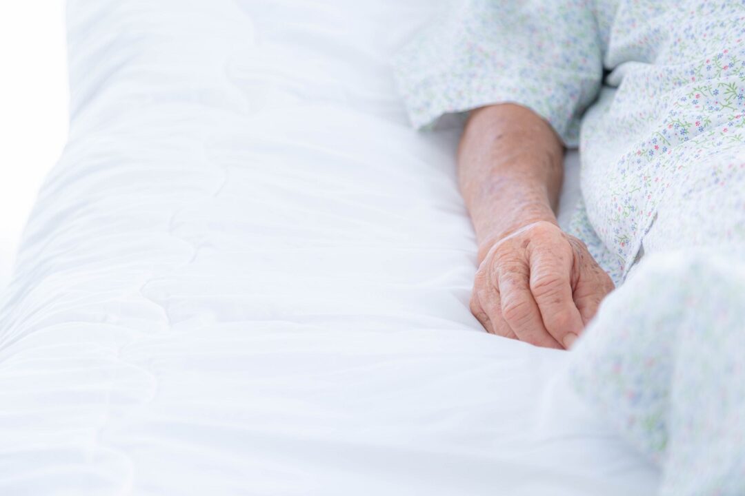 Hands Of An Old Woman In The Hospital Room Or Nursing Home.