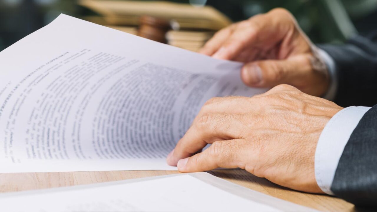 Male Lawyer S Hand Holding Document Desk Courtroom