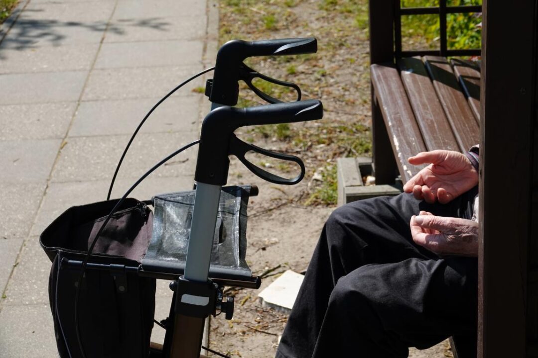 Midsection Senior Man Sitting By Mobility Walker Bench 1