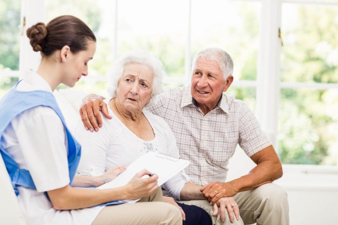 Nurse Taking Care Of Sick Elderly Patients At Home