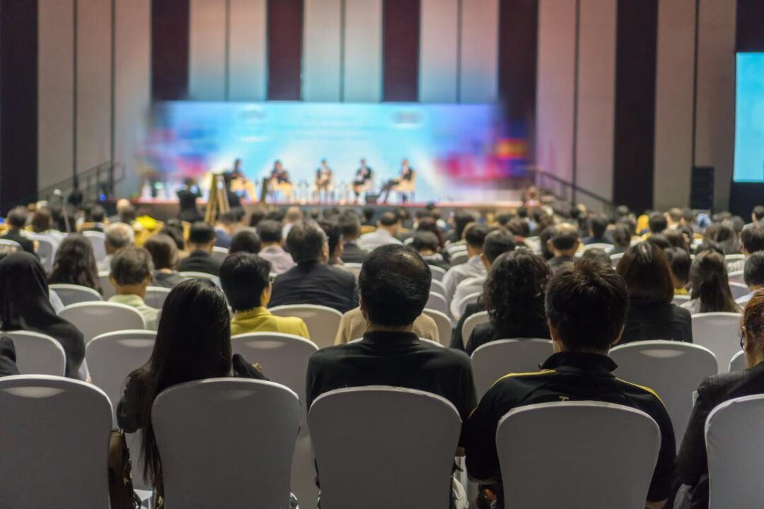 Rear View Audience Listening Speakers Stage Conference Hall Seminar Meeting