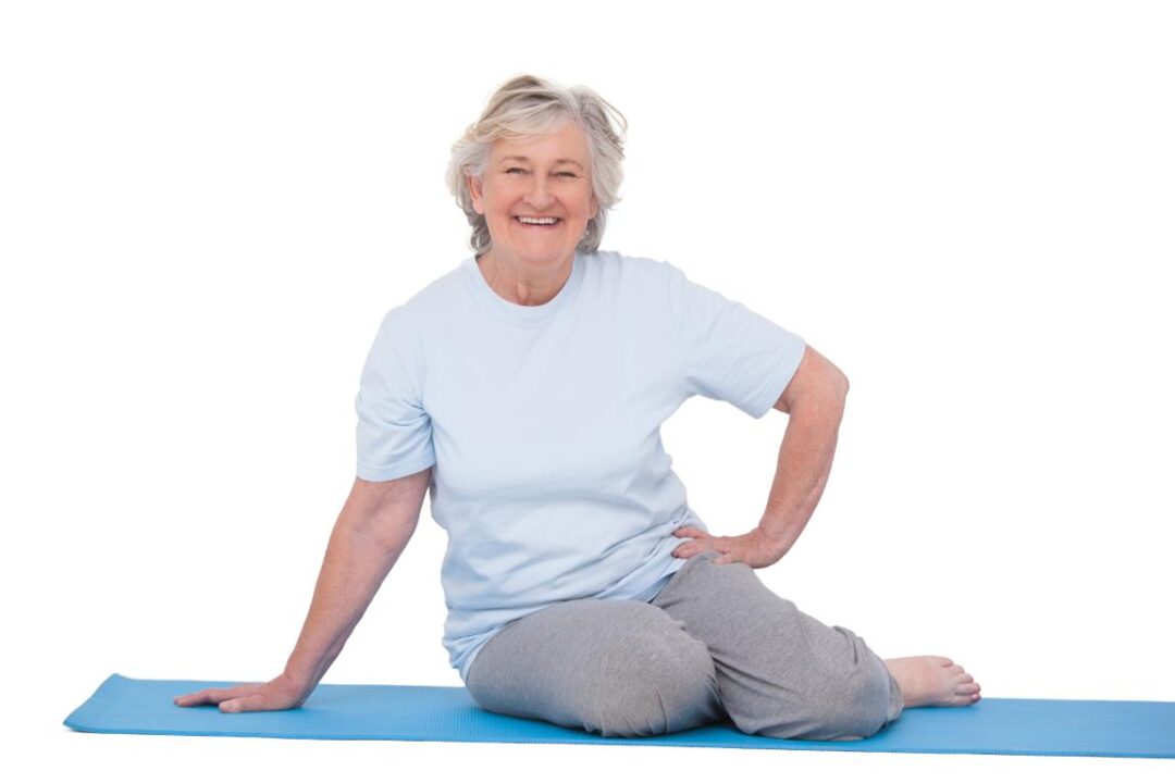 Senior Woman Smiling On Exercise Mat