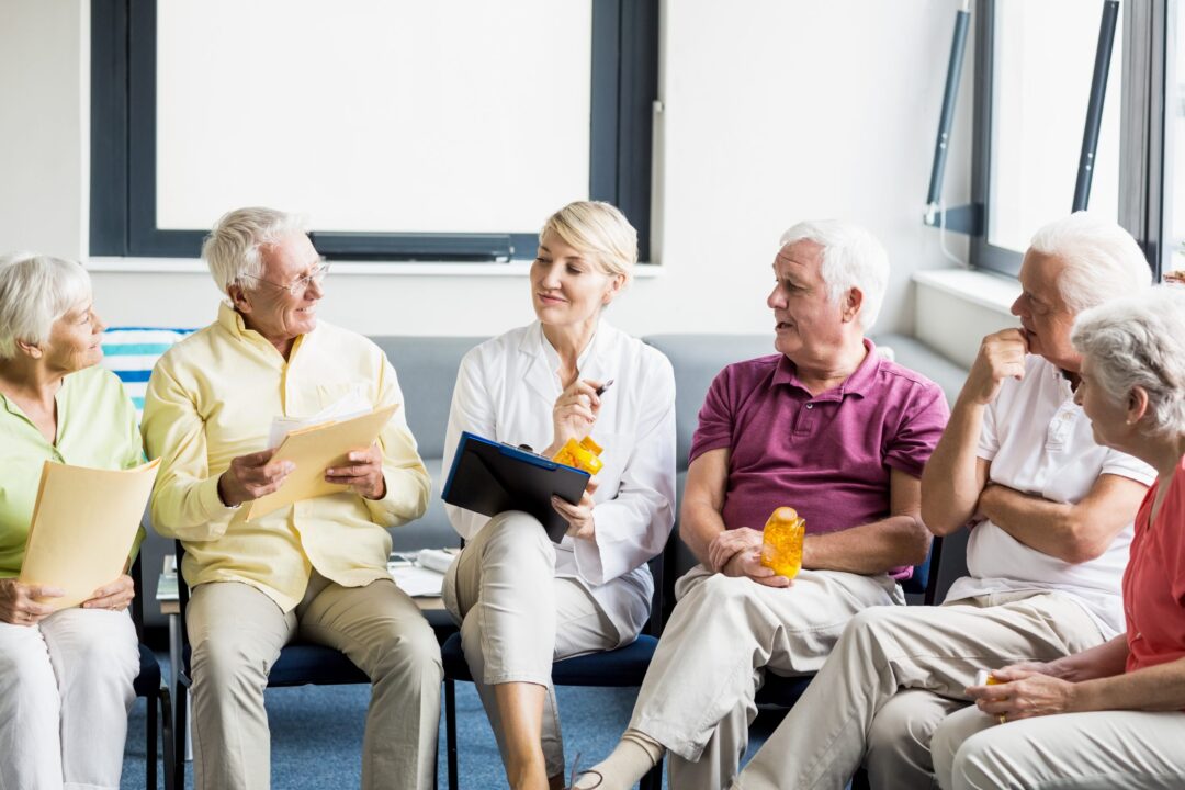 seniors-and-nurse-holding-documents-scaled
